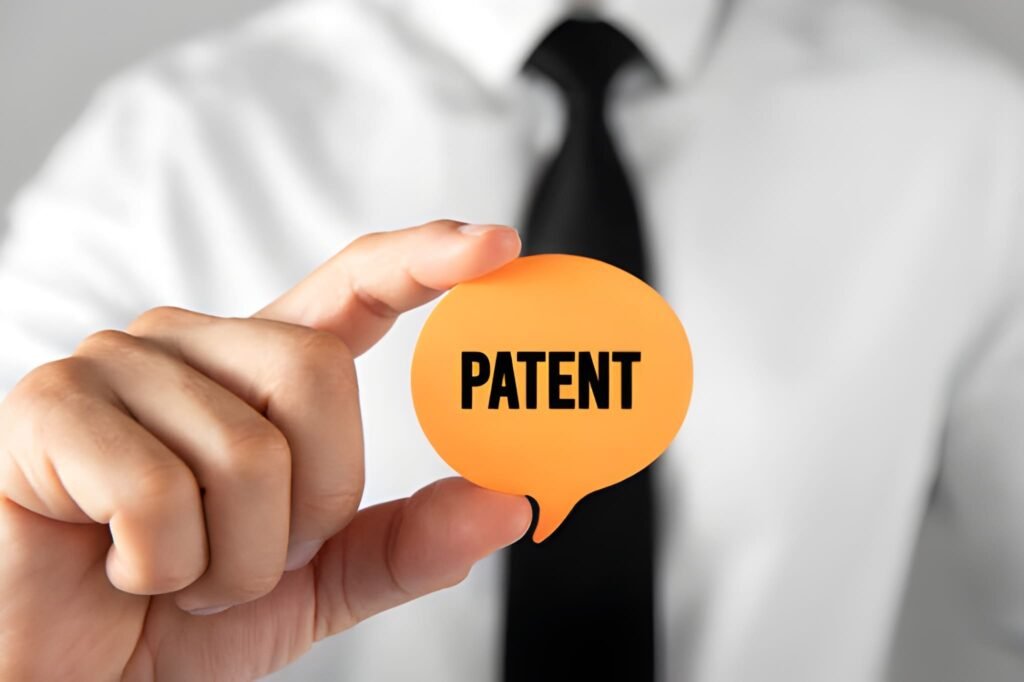 A businessman holding a small orange speech bubble with the word 'PATENT' on it, next to text explaining the 20-year patent lifespan and renewal considerations.