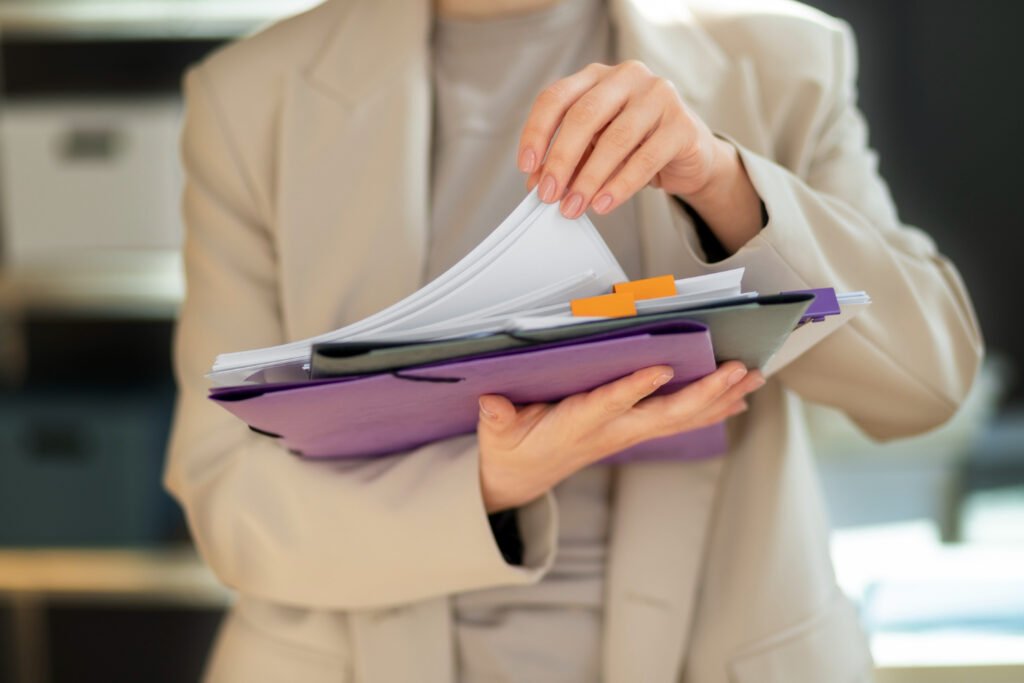 A guide comparing when to deploy pre-grant versus post-grant patent opposition, featuring a professional holding legal files.
