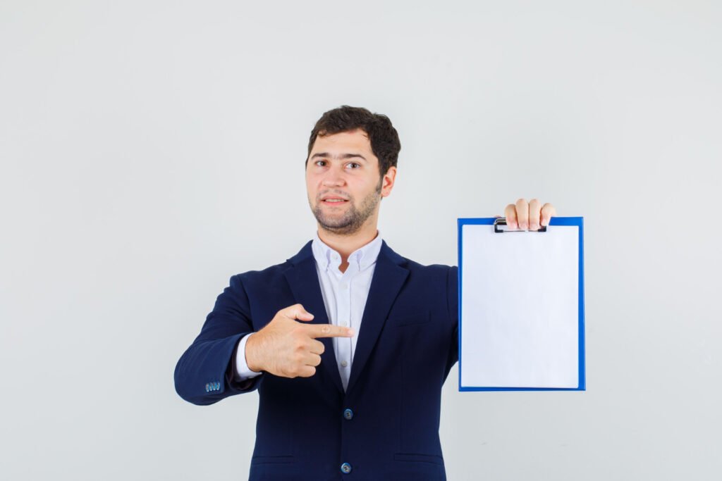 A man holding a clipboard and pointing at a document, representing the paperwork needed to file an intellectual property or copyright application.