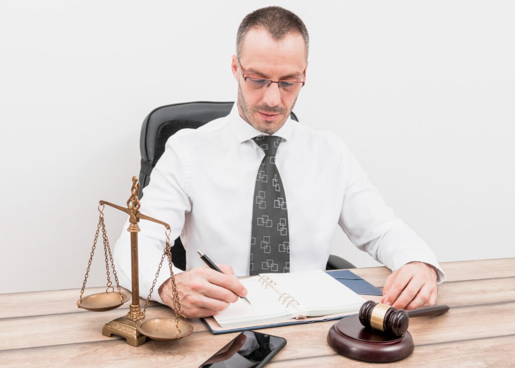 A legal professional at a desk with a scale of justice, next to text explaining why patent law requires public disclosure.
