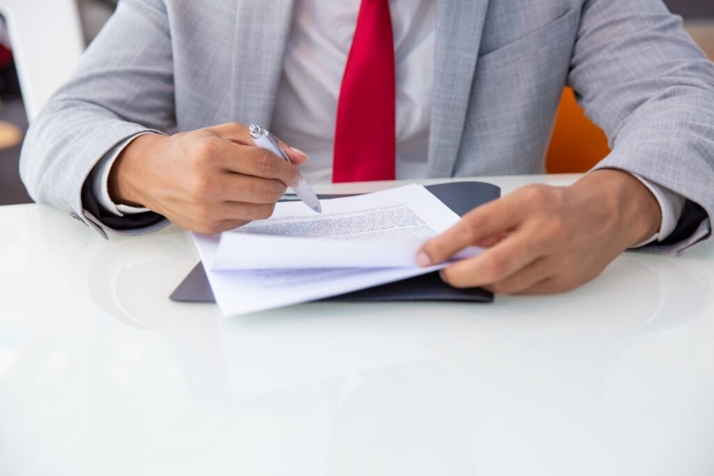 A professional in a suit reviewing legal documents and managing a patent secrecy order.